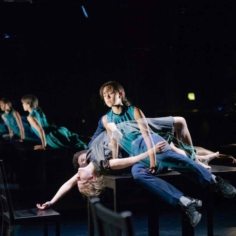 After Image photo 1 dancer lead back on a table with another dancer appearing to come out of the body in a ghostly way