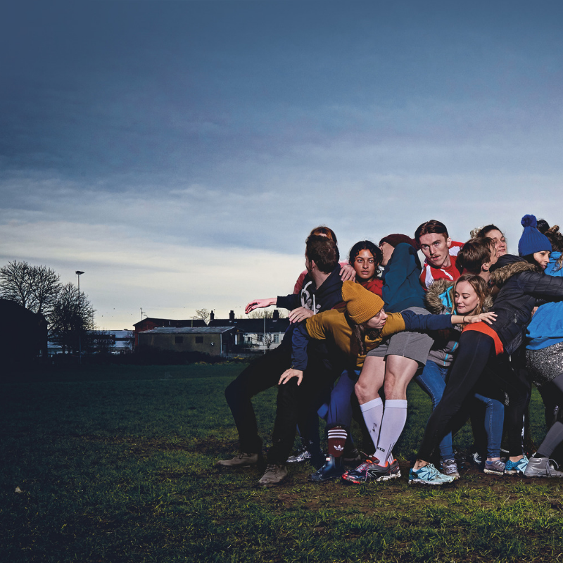 rugby huddle with blue sky