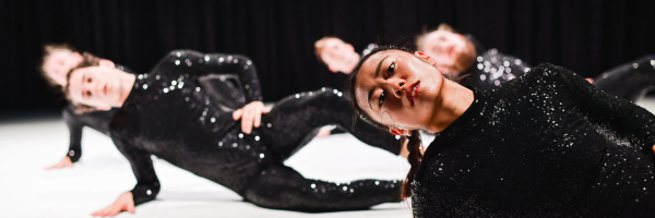 dancers in black sequin jumpsuits