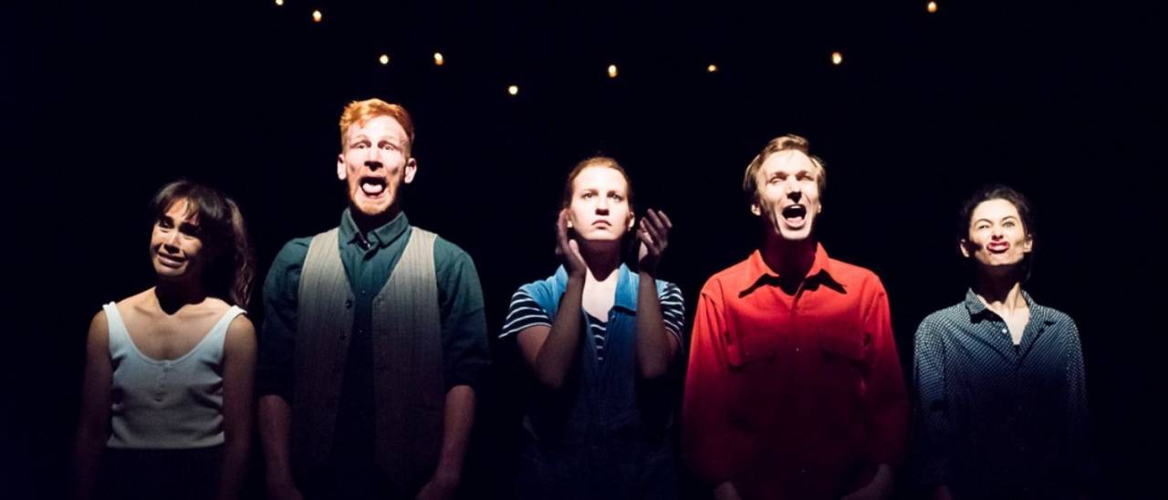 5 dancers stood at the front pulling faces and the one in the centre clapping