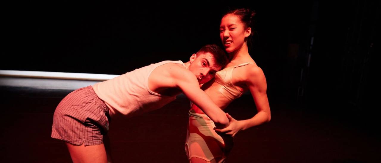 2 dancers, 1 with his head on her chest