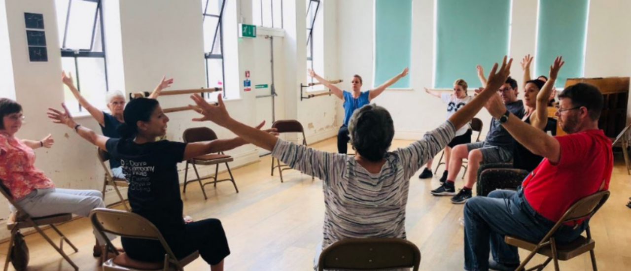 Dance class in a room looking at each other