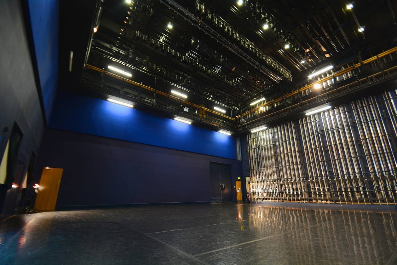 A photograph of the blue room - ti is a large dance studio with blue seats and walls