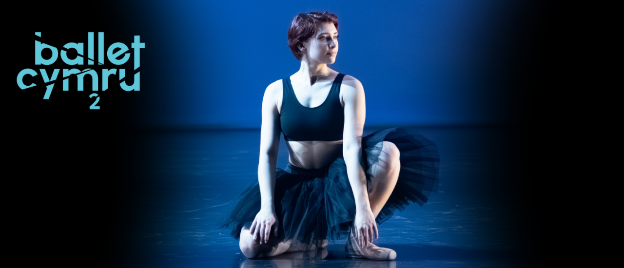 young dancer in black tutu and a cropped black sports bra