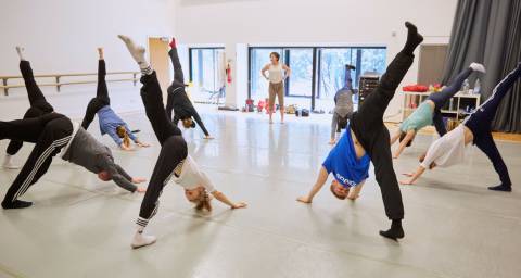 company class - dancers warming up in a circle