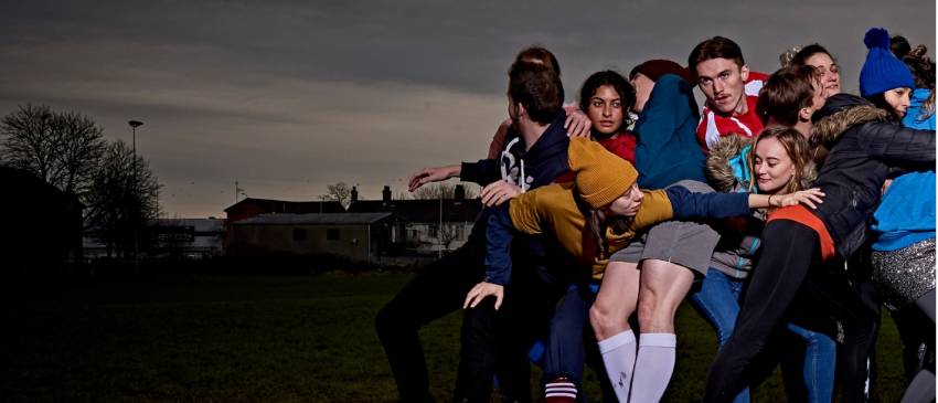 Huddle of people in the right corner, dark grey skies
